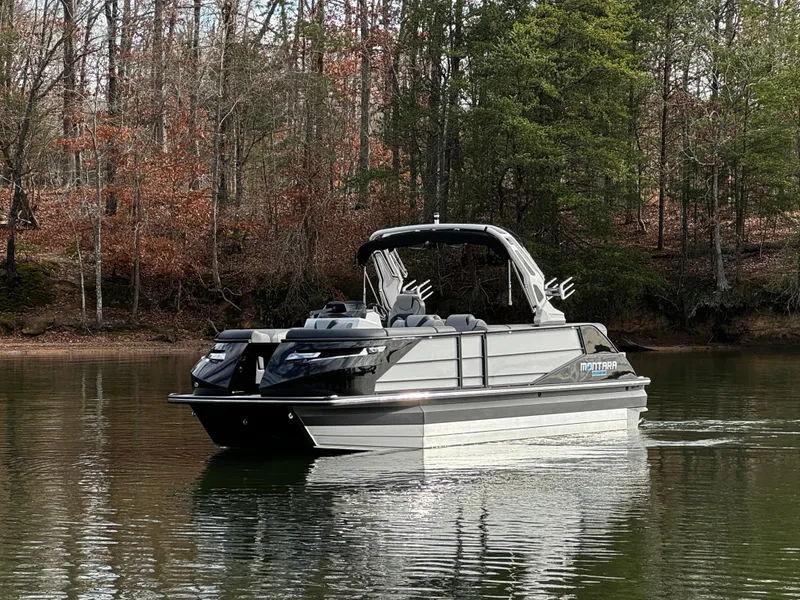 Slide: The Image of 2025 Montara Surf Boss 2.0 25 boat on a calm lake, surrounded by trees. - 3