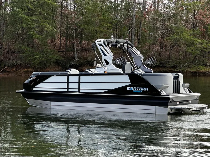 Slide: The Image of 2025 Montara Surf Boss 2.0 25 pontoon boat on a calm lake. - 5