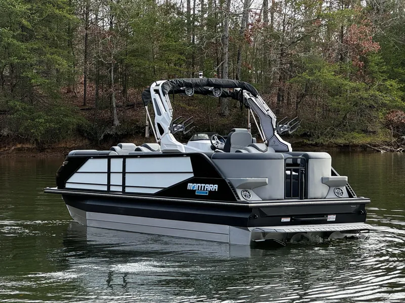 Slide: The Image of 2025 Montara Surf Boss 2.0 25 pontoon boat on a serene lake. - 6