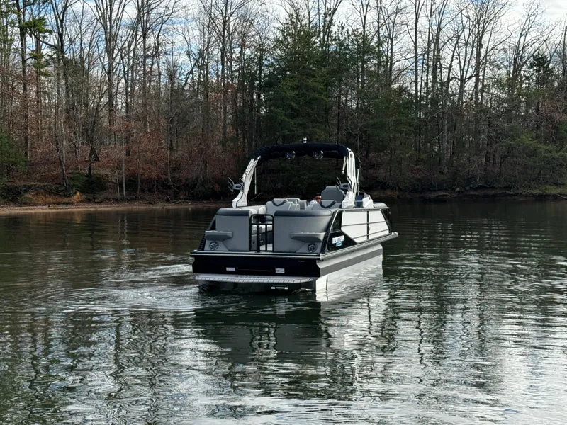 Slide: The Image of 2025 Montara Surf Boss 2.0 25 boat cruising on a calm lake. - 8
