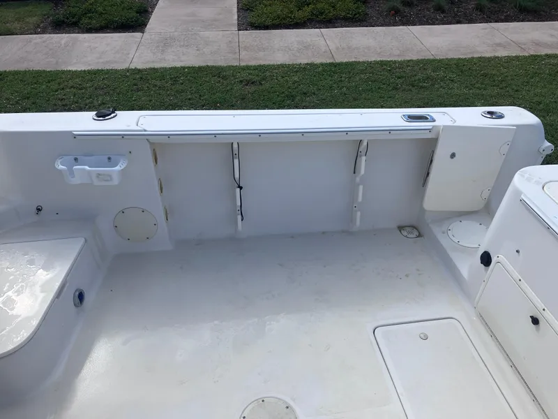 Slide: The Image of 1998 Pro-Line 241 Walkaround boat deck, featuring spacious seating and storage compartments. - 14