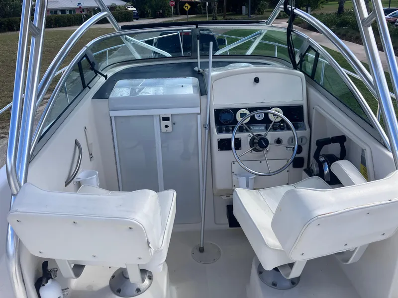 Slide: The Image of 1998 Pro-Line 241 Walkaround boat cockpit with steering wheel and seating. - 16