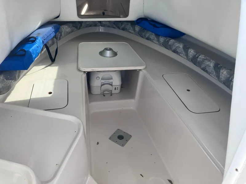 Slide: The Image of 1998 Pro-Line 241 Walkaround cabin interior with seating and table. - 18