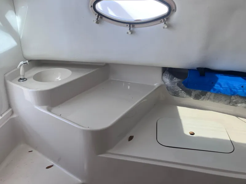 Slide: The Image of 1998 Pro-Line 241 Walkaround cabin interior with sink and storage area. - 19