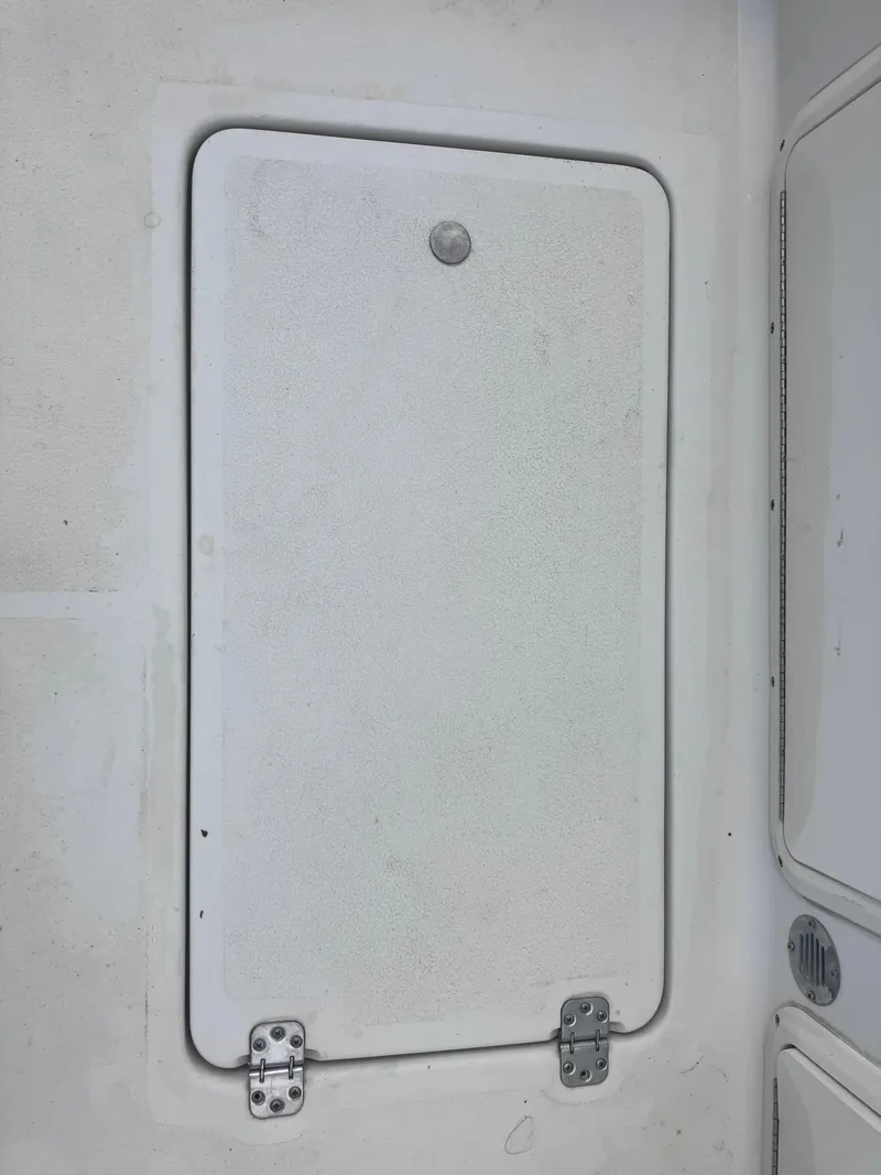 Slide: The Image of 1998 Pro-Line 241 Walkaround boat hatch with hinges, white surface. - 27