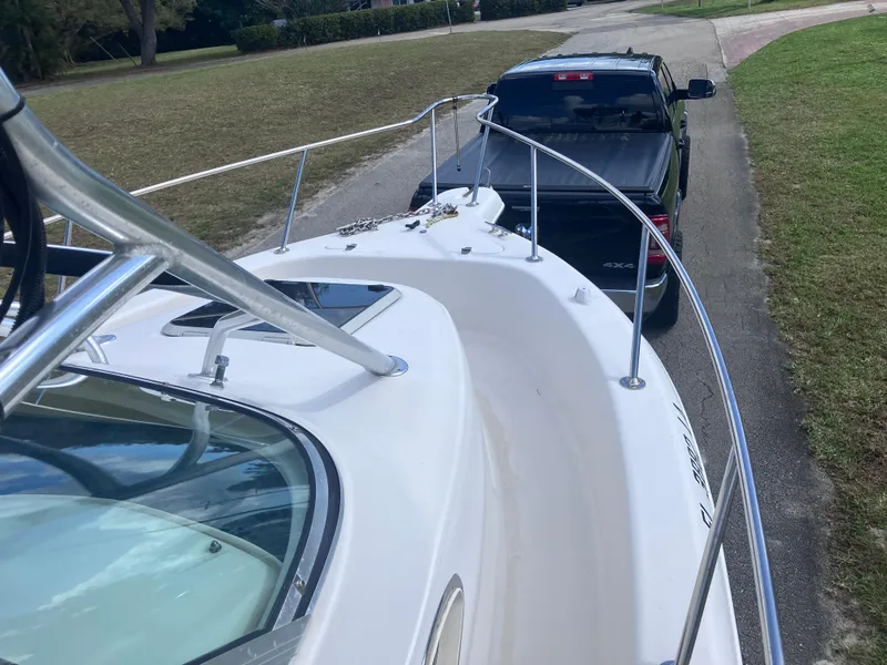 Slide: The Image of 1998 Pro-Line 241 Walkaround boat on trailer, hitched to a black pickup truck. - 34