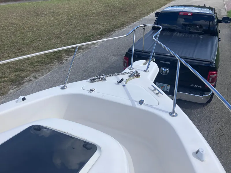 Slide: The Image of 1998 Pro-Line 241 Walkaround boat being towed by a black pickup truck on a road. - 35