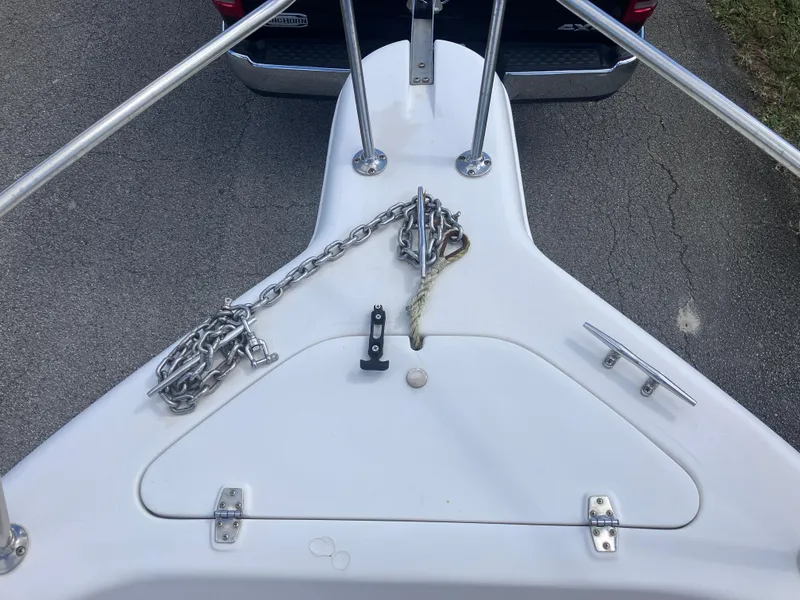 Slide: The Image of 1998 Pro-Line 241 Walkaround boat bow with anchor chain and cleats. - 36