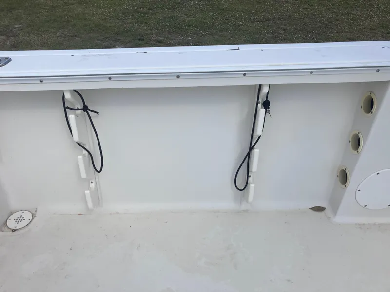 Slide: The Image of 1998 Pro-Line 241 Walkaround boat interior with rod holders and clean deck. - 44