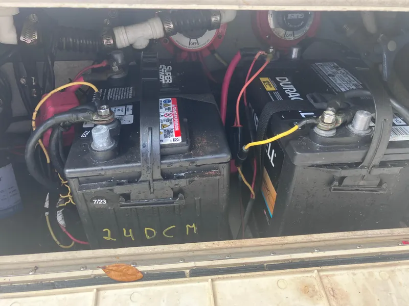 Slide: The Image of Batteries in a 1998 Pro-Line 241 Walkaround boat, showing wiring and connections. - 47