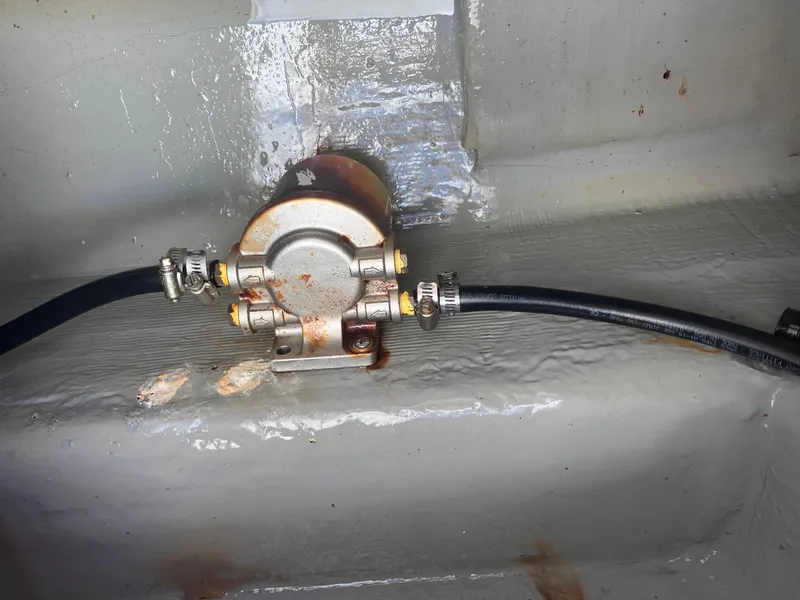 Slide: The Image of 1998 Pro-Line 241 Walkaround bilge pump with attached hoses. - 49