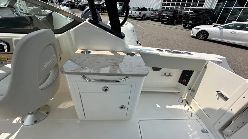Slide: The Image of 2025 Boston Whaler 240 Vantage boat interior with seating and storage area. - 11