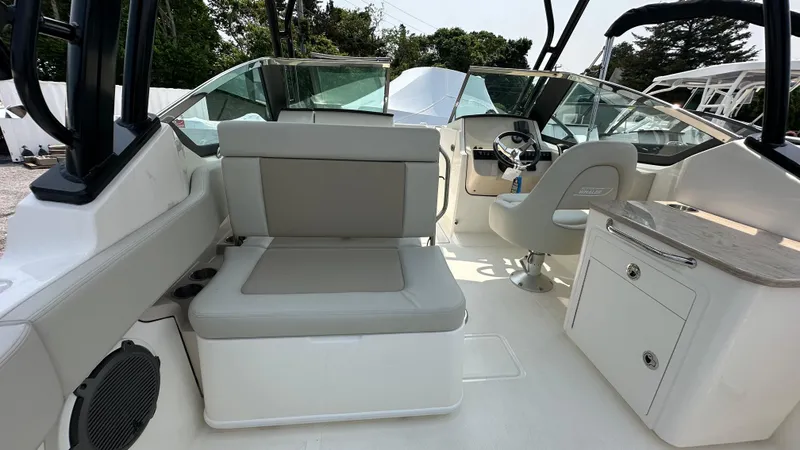 Slide: The Image of 2025 Boston Whaler 240 Vantage boat interior with seating and helm station. - 13