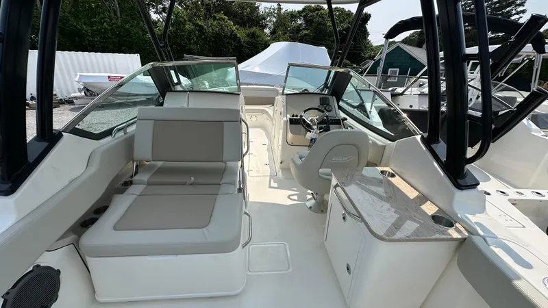 Slide: The Image of 2025 Boston Whaler 240 Vantage boat interior with seating and helm, showcasing modern design. - 14