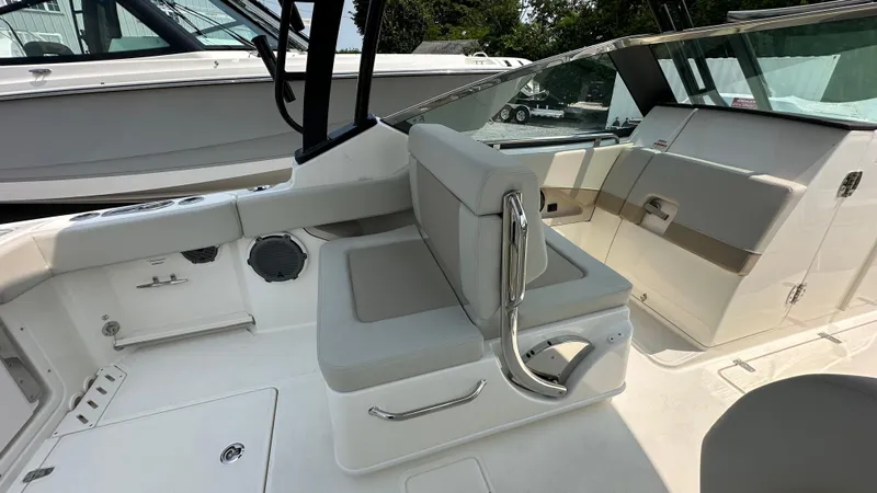 Slide: The Image of 2025 Boston Whaler 240 Vantage boat interior with cushioned seating and sleek design. - 16