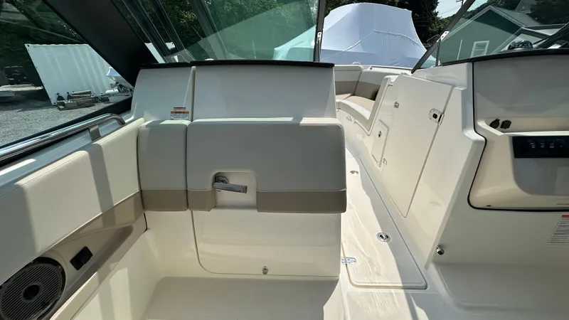 Slide: The Image of 2025 Boston Whaler 240 Vantage interior, showcasing seating and storage compartments. - 19