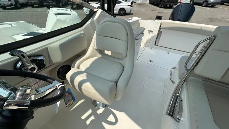 Slide: The Image of 2025 Boston Whaler 240 Vantage boat interior with helm seat and steering wheel. - 22