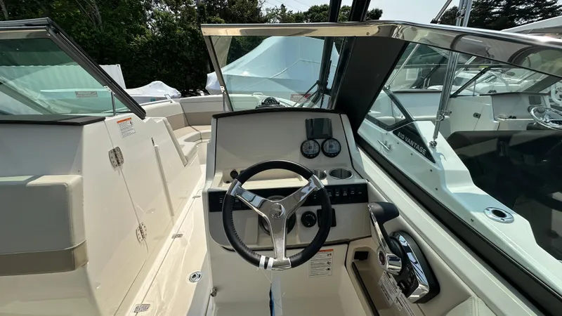 Slide: The Image of 2025 Boston Whaler 240 Vantage boat cockpit with steering wheel and gauges. - 24