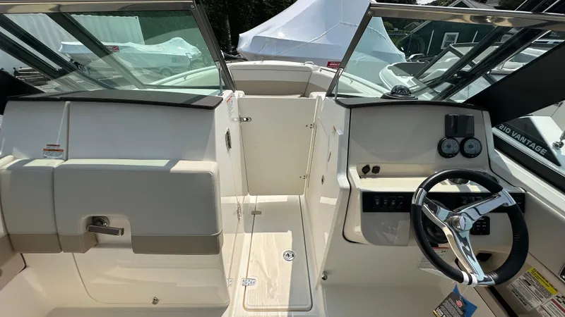 Slide: The Image of 2025 Boston Whaler 240 Vantage boat interior with steering wheel and dashboard controls. - 26