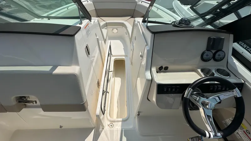 Slide: The Image of 2025 Boston Whaler 240 Vantage boat interior with steering wheel and dashboard controls. - 27