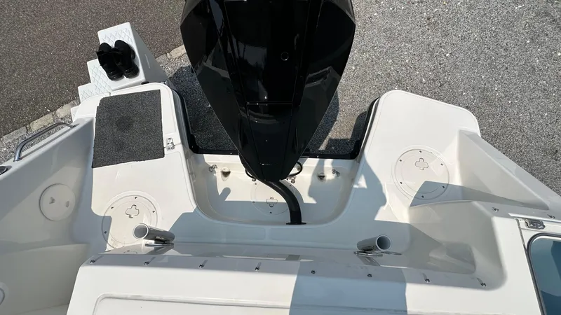 Slide: The Image of 2025 Boston Whaler 240 Vantage boat deck with engine and seating area. - 3