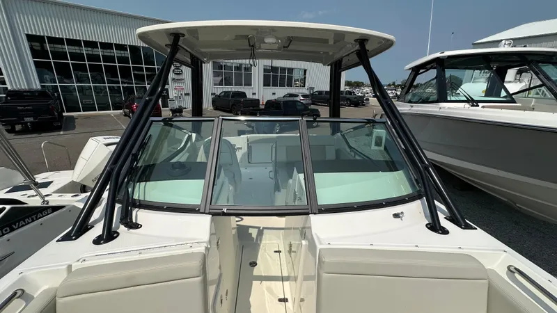 Slide: The Image of 2025 Boston Whaler 240 Vantage boat with sleek design and spacious seating at a marina. - 30