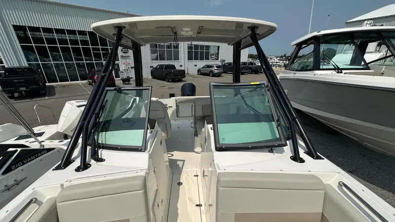 Slide: The Image of 2025 Boston Whaler 240 Vantage boat, dual consoles, docked at marina. - 31