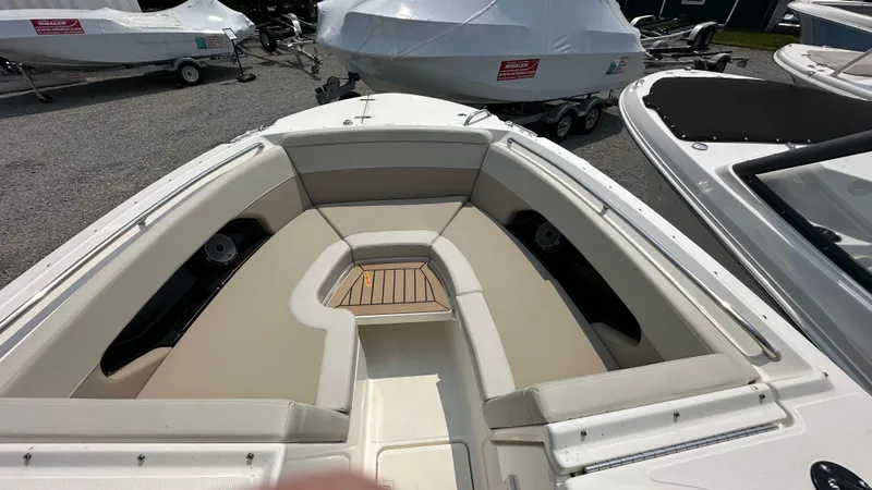 Slide: The Image of 2025 Boston Whaler 240 Vantage boat interior with cushioned seating and wood accents. - 34