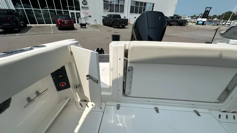Slide: The Image of 2025 Boston Whaler 240 Vantage boat interior with open storage compartment and seating. - 5