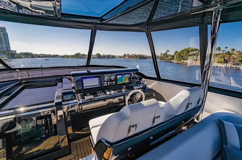 Slide: The Image of Luxurious 2019 Riva ARGO yacht cockpit with modern navigation system and scenic waterfront view. - 22