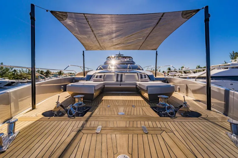Slide: The Image of Luxurious 2019 Riva ARGO yacht with sunshade, wooden deck, and sleek design in a marina setting. - 23