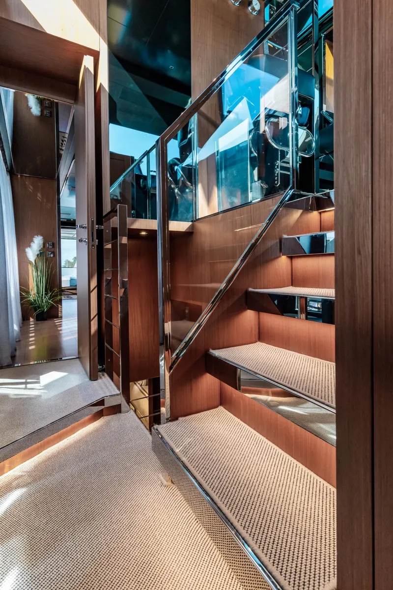Slide: The Image of Luxurious interior of 2019 Riva ARGO yacht featuring modern wooden staircase and elegant design. - 9