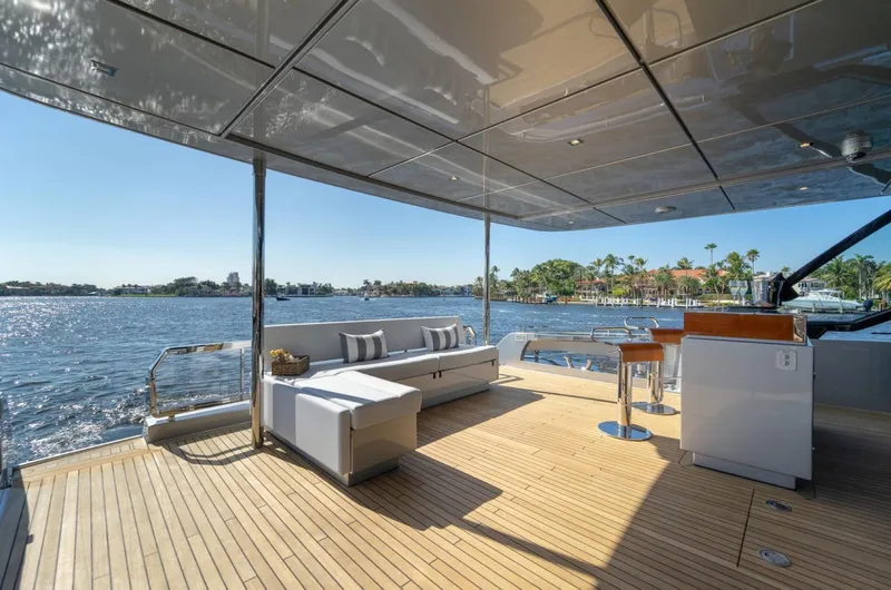 Slide: The Image of Luxurious 2019 Riva ARGO yacht deck with seating, overlooking serene water and distant shoreline. - 1