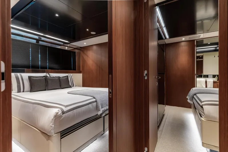 Slide: The Image of Luxurious bedroom interior of 2019 Riva ARGO yacht with elegant wood paneling and modern lighting. - 16