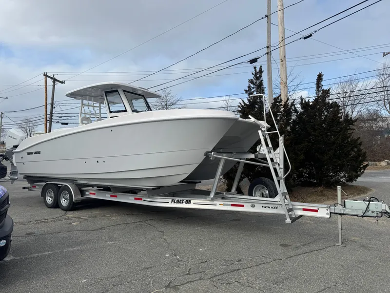 The Image of 2025 Twin Vee 280 GFX2 CC boat on trailer, parked outdoors. - 0