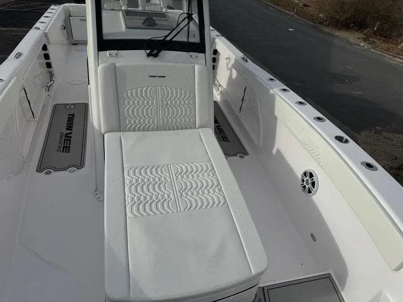 Slide: The Image of 2025 Twin Vee 280 GFX2 CC boat interior with white seating and console. - 10