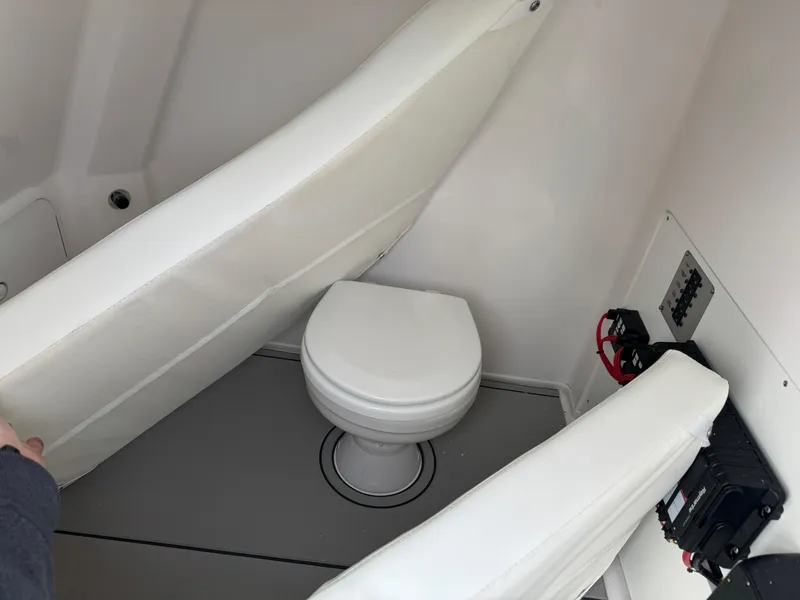 Slide: The Image of 2025 Twin Vee 280 GFX2 CC boat interior with compact marine toilet. - 12