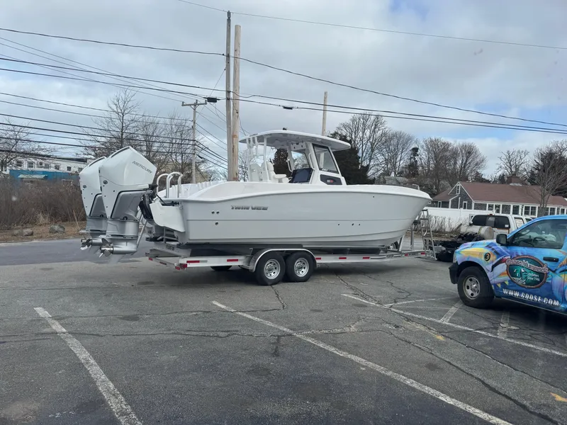 Slide: The Image of 2025 Twin Vee 280 GFX2 CC boat on trailer in parking lot. - 2