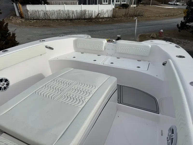 Slide: The Image of 2025 Twin Vee 280 GFX2 CC boat interior with white seating and storage compartments. - 9