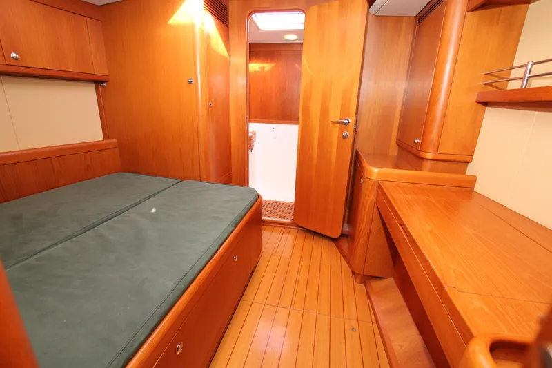 Slide: The Image of Nautor Swan 46mkIII 2006 yacht cabin with wooden interior and green bedding. - 34
