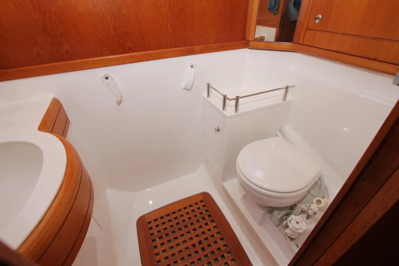 Slide: The Image of Bathroom interior of 2006 Nautor Swan 46mkIII yacht with wooden accents and white fixtures. - 37