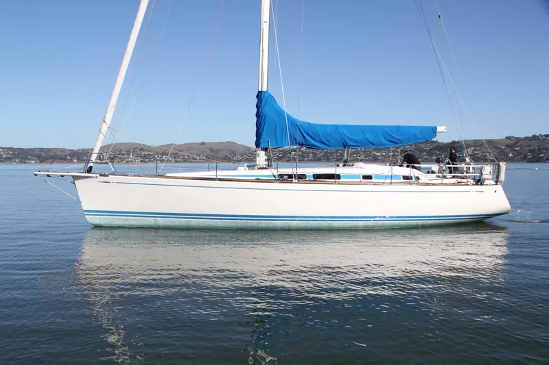 Slide: The Image of 2006 Nautor Swan 46mkIII sailboat with blue sail cover on calm water. - 4