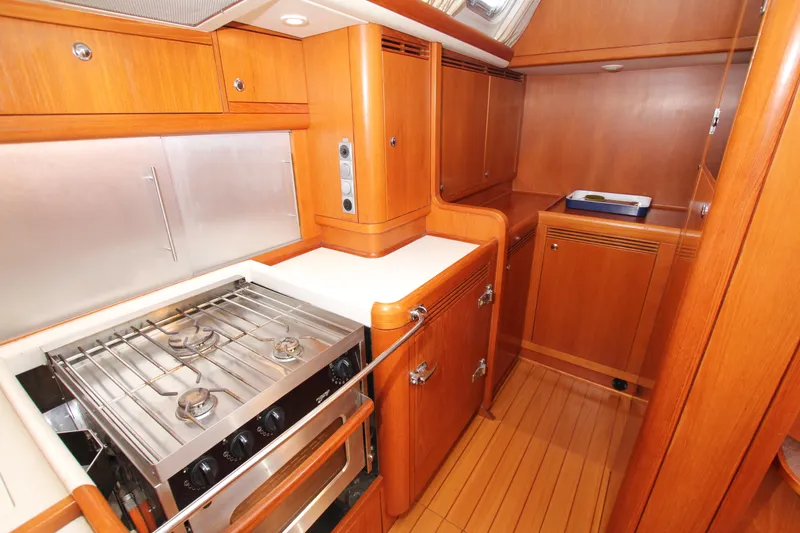 Slide: The Image of Luxurious wooden interior of 2006 Nautor Swan 46mkIII yacht kitchen with stove and cabinets. - 45