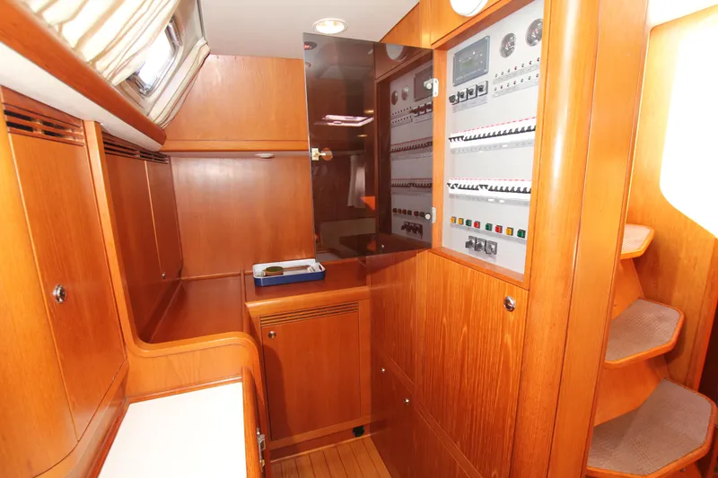 Slide: The Image of Interior of 2006 Nautor Swan 46mkIII yacht with wooden cabinetry and control panels. - 46
