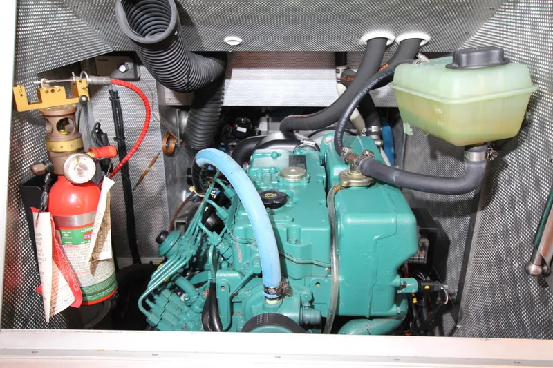 Slide: The Image of Engine compartment of 2006 Nautor Swan 46mkIII yacht, featuring a green engine and fire extinguisher. - 50