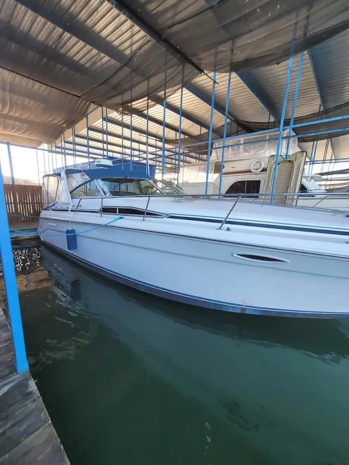 Slide: The Image of 1991 Sea Ray 350 Express Cruiser in covered dock. - 2
