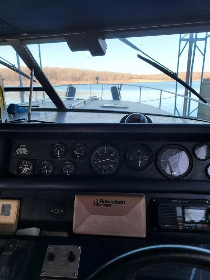 Slide: The Image of Dashboard of a 1991 Sea Ray 350 Express Cruiser with lake view. - 7