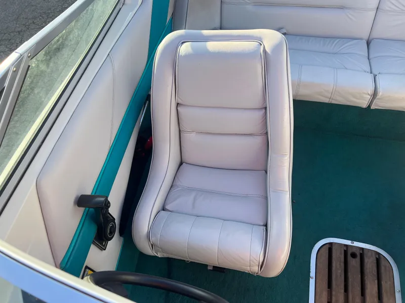 Slide: The Image of White leather seat in a 1992 Celebrity 180 Bowrider boat interior. - 15