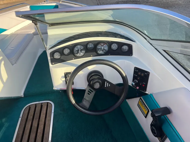 Slide: The Image of 1992 Celebrity 180 Bowrider boat dashboard with steering wheel and instrument panel. - 16
