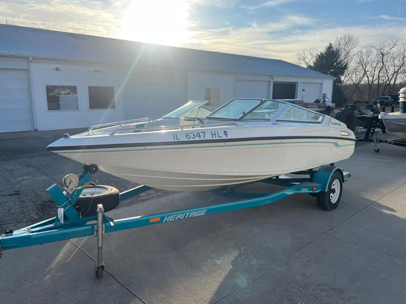 Slide: The Image of 1992 Celebrity 180 Bowrider boat on trailer, parked outdoors in sunlight. - 3